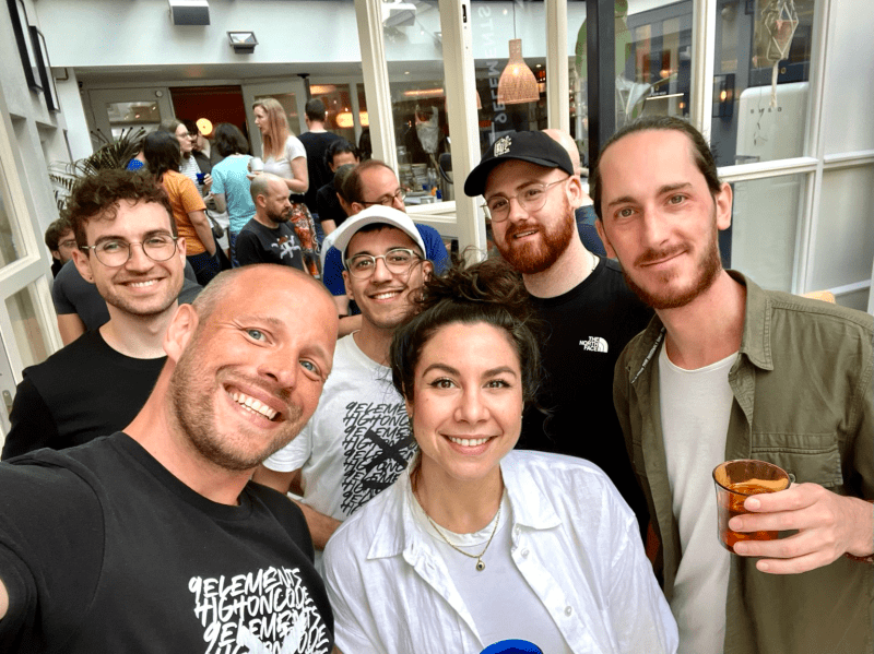 a group selfie of people in a hotel lobby, smiling faces all around