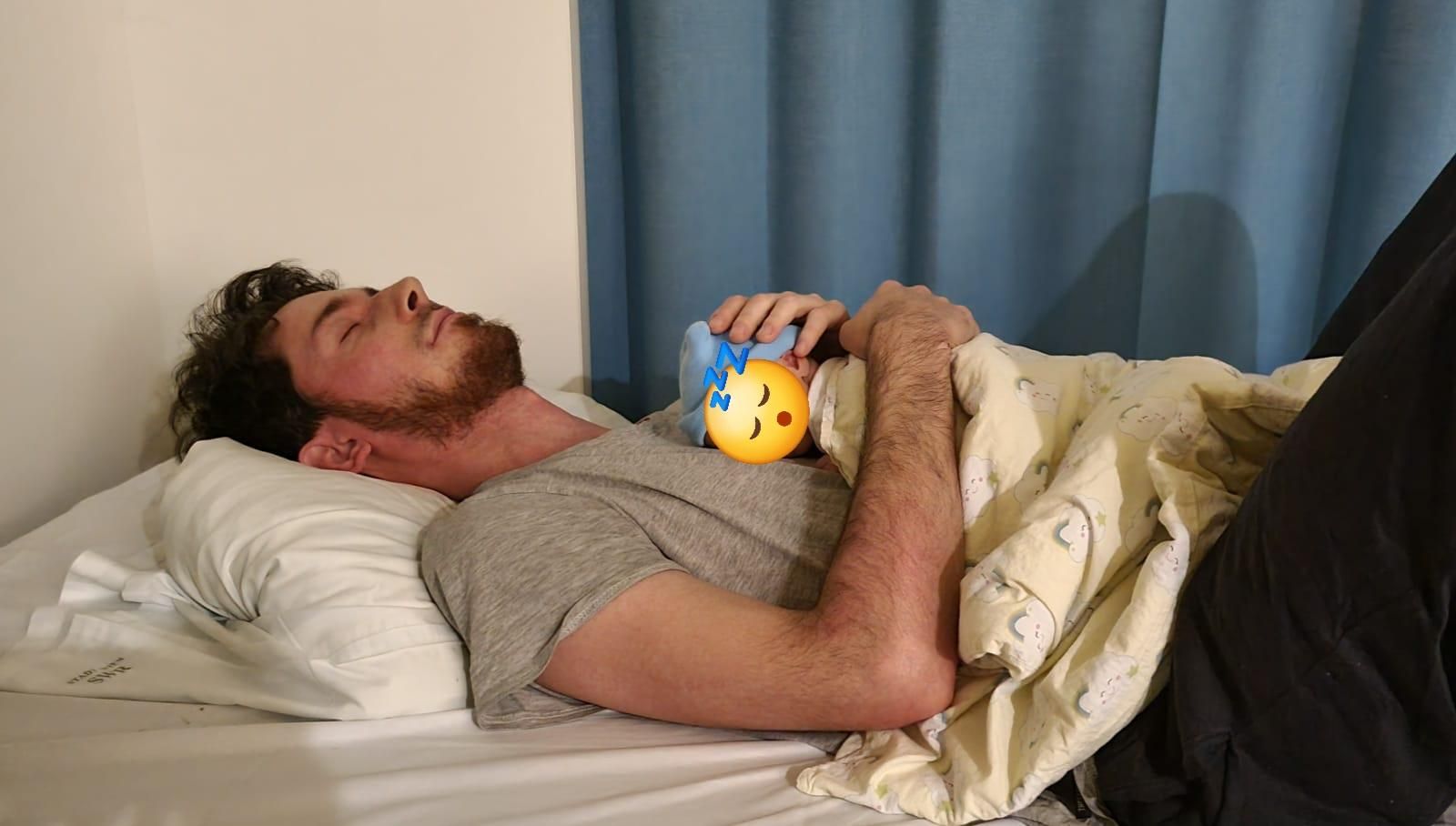 me with a sleeping baby on my chest, exhausted in the hospital
